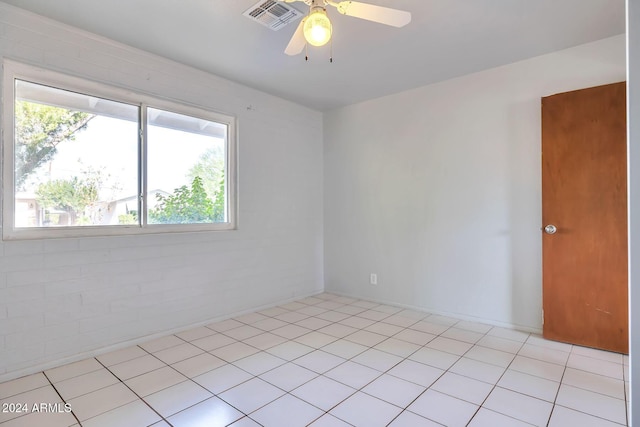 spare room featuring light tile patterned floors and ceiling fan