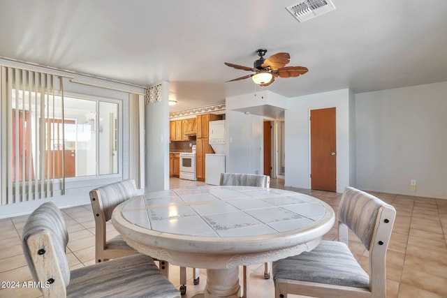 tiled dining room featuring ceiling fan