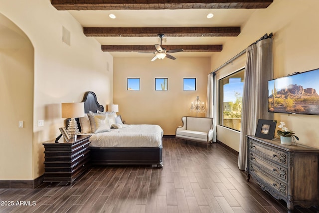 bedroom with arched walkways, dark wood-style floors, and beam ceiling