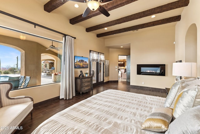 bedroom with arched walkways, baseboards, beamed ceiling, and wood finished floors