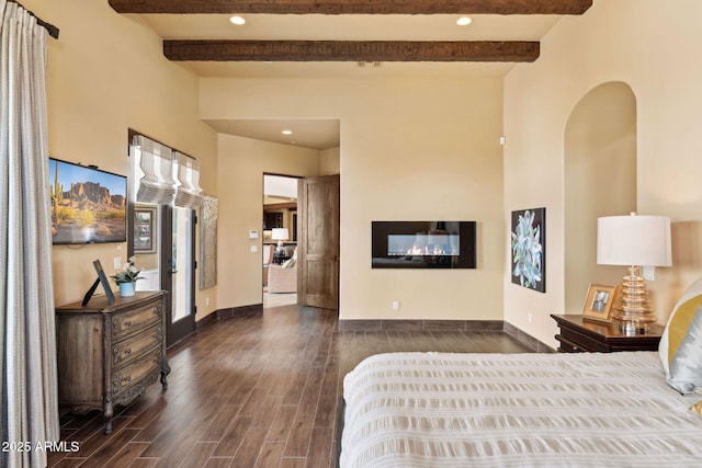 bedroom featuring baseboards, beamed ceiling, recessed lighting, and wood finished floors