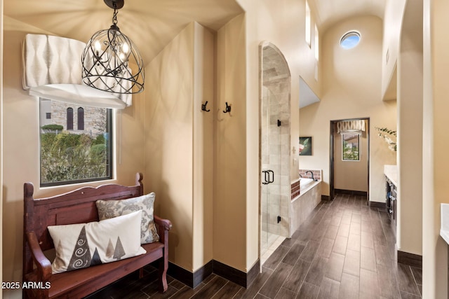 interior space featuring baseboards and wood tiled floor