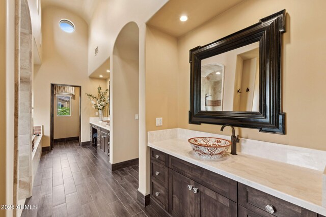 full bathroom with baseboards, vanity, wood finished floors, and visible vents
