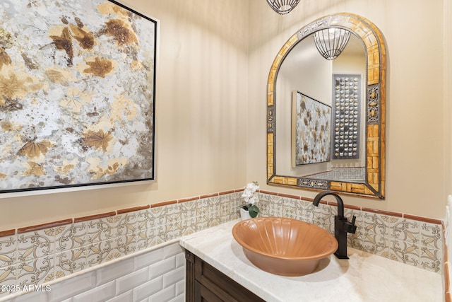 bathroom featuring vanity, wainscoting, and tile walls
