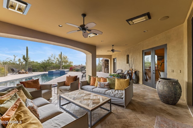 view of patio with fence, a pool with connected hot tub, an outdoor hangout area, french doors, and a ceiling fan