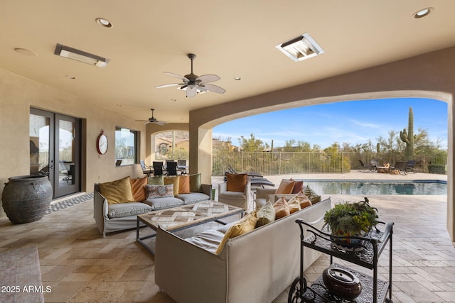 view of patio / terrace with a fenced in pool, ceiling fan, outdoor lounge area, and fence