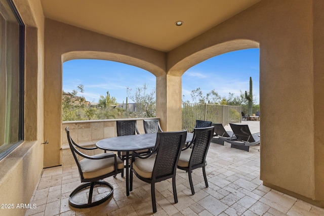 view of patio featuring fence and outdoor dining area