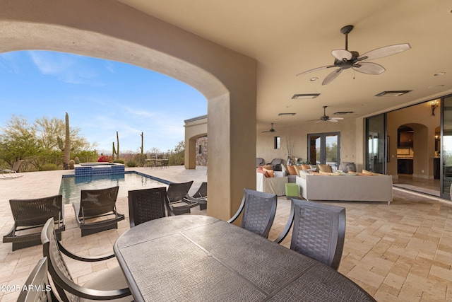 view of patio with ceiling fan, a pool with connected hot tub, outdoor dining space, and an outdoor hangout area
