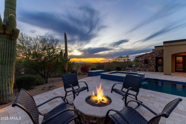 view of patio / terrace featuring an outdoor fire pit and a pool with connected hot tub