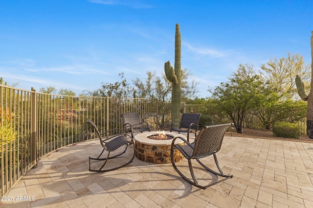 view of patio featuring fence and an outdoor fire pit