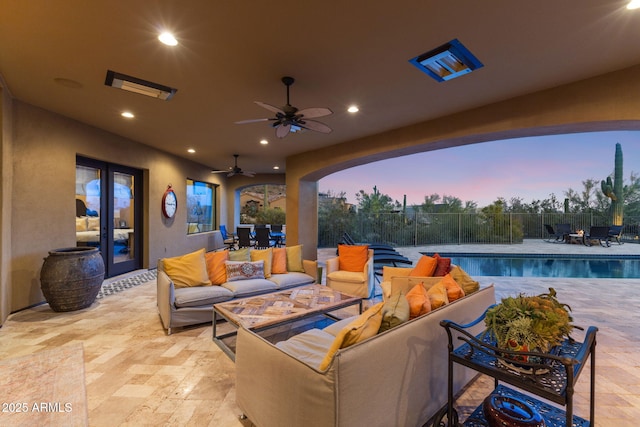 view of patio / terrace featuring ceiling fan, french doors, fence, a fenced in pool, and an outdoor hangout area