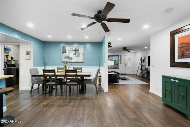 dining room featuring dark wood finished floors, recessed lighting, baseboards, and washing machine and clothes dryer