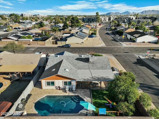 drone / aerial view featuring a residential view and a mountain view