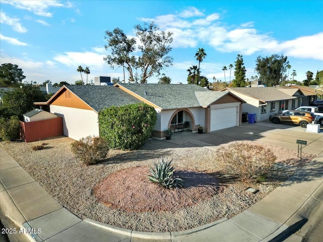 ranch-style house with stucco siding, concrete driveway, a garage, and a shingled roof