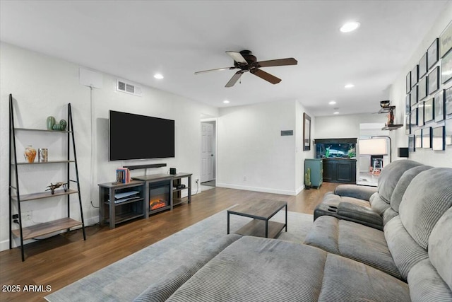 living room featuring visible vents, recessed lighting, and wood finished floors