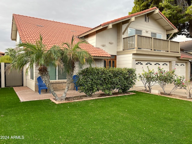 view of front facade with a front yard, a balcony, and a garage