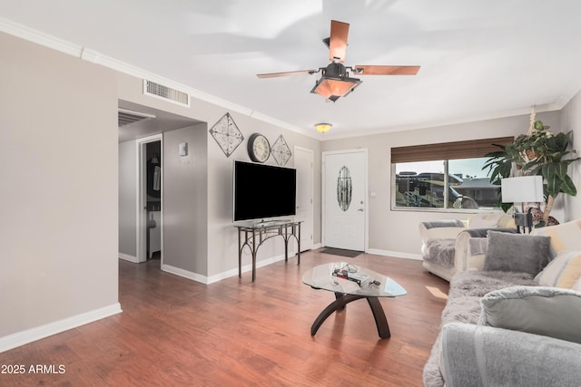 living room featuring ceiling fan, wood-type flooring, and crown molding