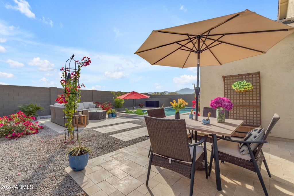 view of patio with outdoor lounge area and a fenced in pool