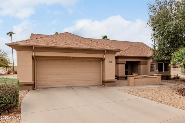 view of front of house featuring a garage, roof with shingles, concrete driveway, and stucco siding