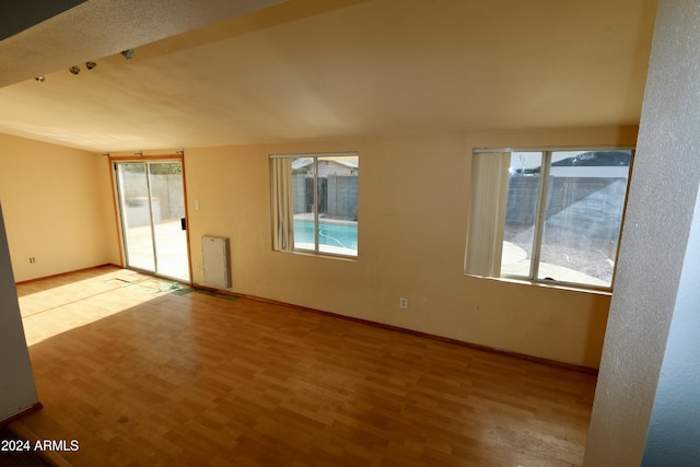 unfurnished room featuring light hardwood / wood-style flooring and plenty of natural light