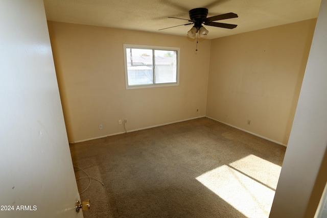 unfurnished room featuring ceiling fan and carpet floors