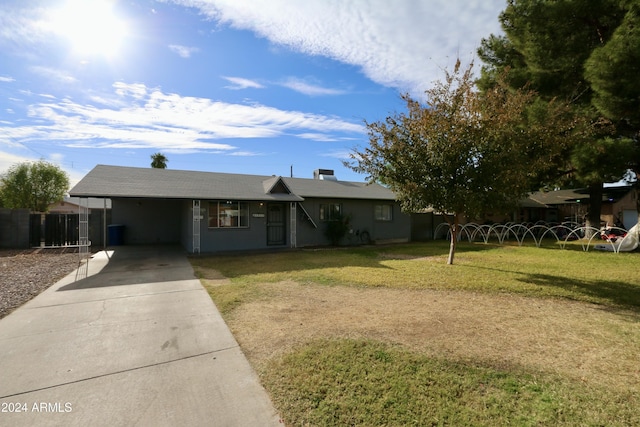 ranch-style home featuring a front lawn and a carport