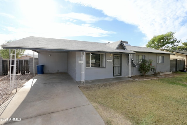 ranch-style house with a front yard and a carport