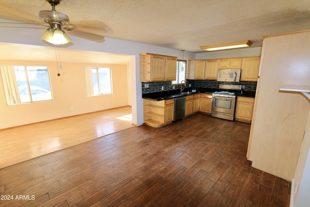 kitchen with light brown cabinets, stainless steel gas range, dark hardwood / wood-style floors, black dishwasher, and tasteful backsplash