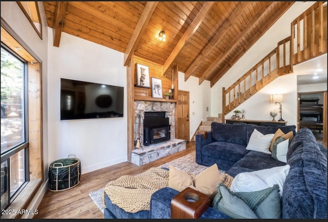 17405 S Shadow Rock Pl, Munds Park, AZ 86017 - living room with stairway, a wooden ceiling with exposed beams, a stone fireplace, wood finished floors, and high vaulted ceiling