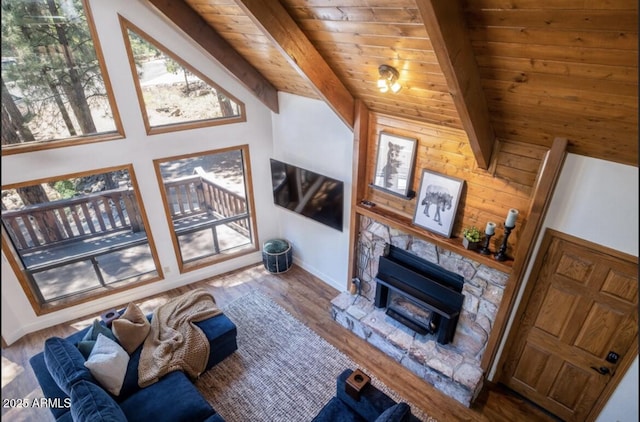 17405 S Shadow Rock Pl, Munds Park, AZ 86017 - living area with a stone fireplace, a wood ceiling with exposed beams, and wood finished floors