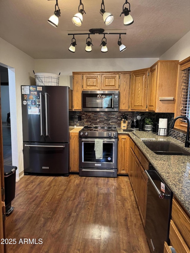17405 S Shadow Rock Pl, Munds Park, AZ 86017 - kitchen with appliances with stainless steel finishes, dark wood-style floors, backsplash, and brown cabinetry