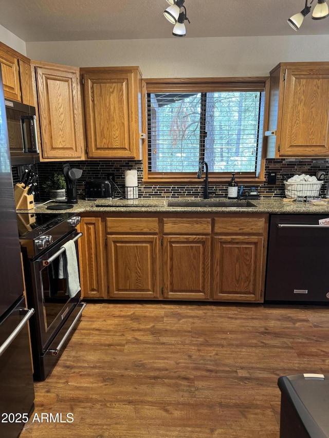 17405 S Shadow Rock Pl, Munds Park, AZ 86017 - kitchen featuring dishwasher, black microwave, stainless steel range oven, backsplash, and wood finished floors