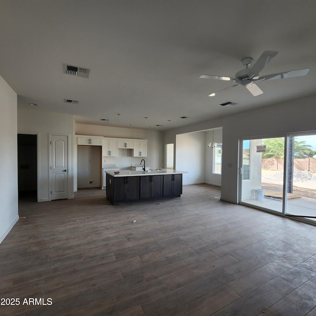 kitchen featuring visible vents, white cabinets, and wood finished floors