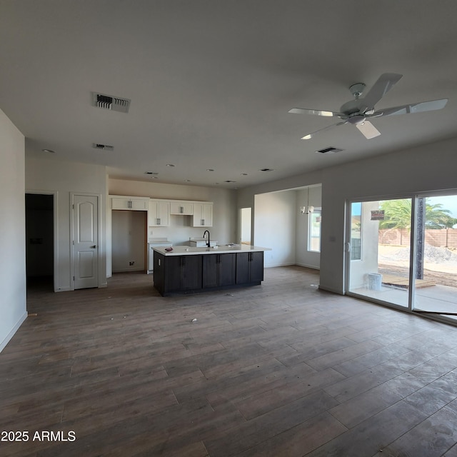 kitchen with white cabinetry, wood-type flooring, sink, a kitchen island with sink, and ceiling fan