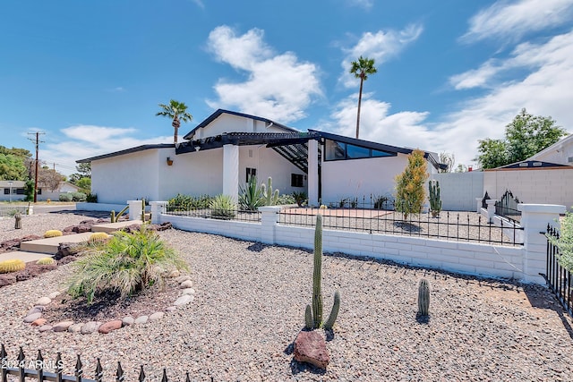 view of home's exterior with a pergola