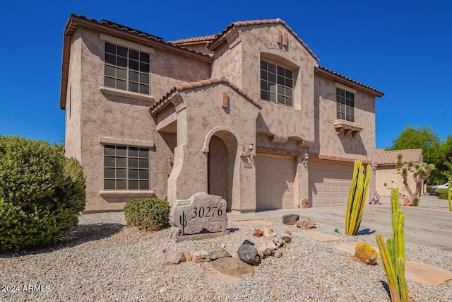 mediterranean / spanish-style home featuring a garage