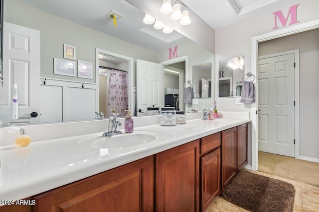 bathroom featuring tile patterned flooring, vanity, and curtained shower