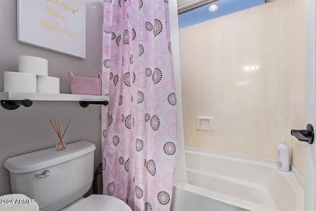 bathroom featuring shower / bath combination with curtain and toilet