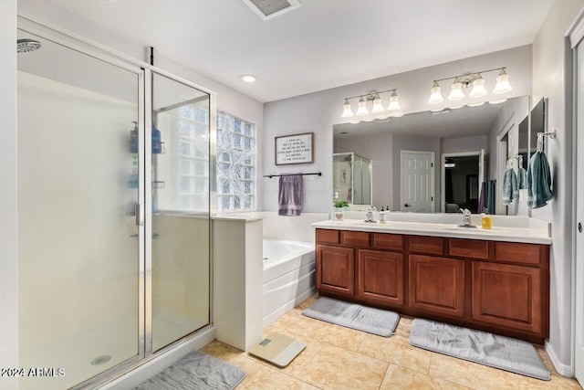 bathroom with tile patterned floors, vanity, and shower with separate bathtub