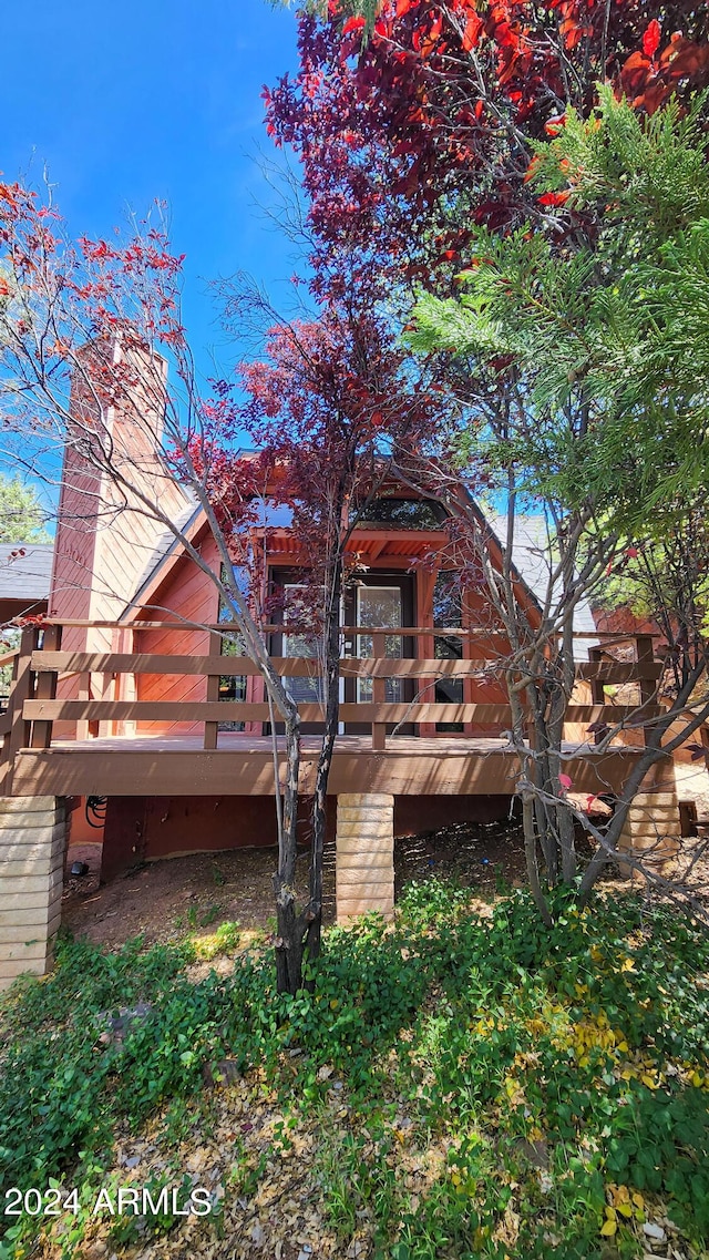 rear view of house featuring a deck