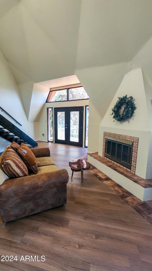 interior space featuring french doors, wood-type flooring, and vaulted ceiling