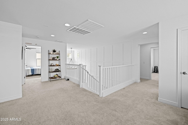 corridor with baseboards, recessed lighting, an upstairs landing, and carpet