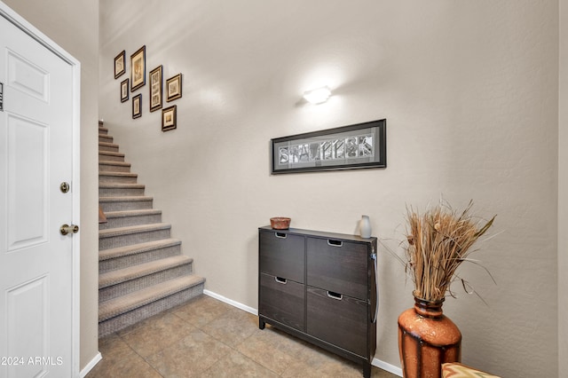 stairs featuring tile patterned floors