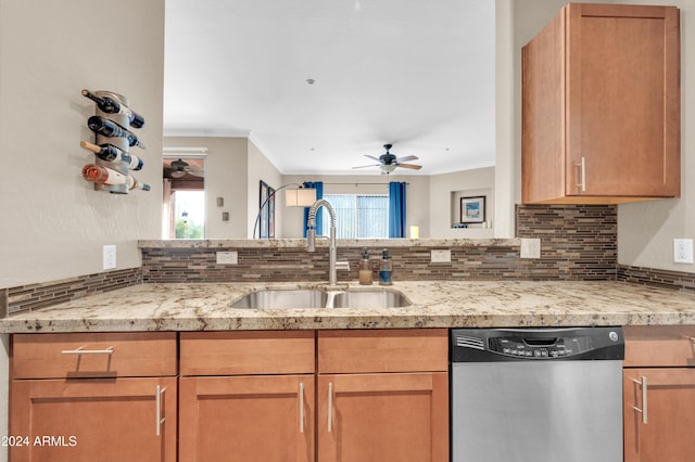 kitchen with stainless steel dishwasher, a wealth of natural light, ornamental molding, and sink