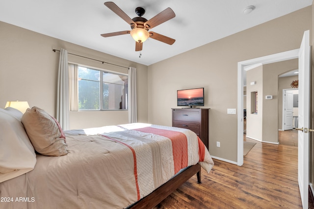 bedroom with ceiling fan and hardwood / wood-style flooring