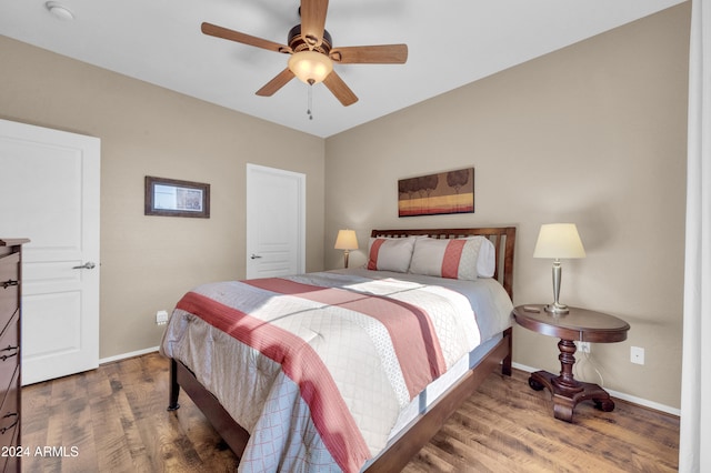 bedroom with ceiling fan and dark wood-type flooring