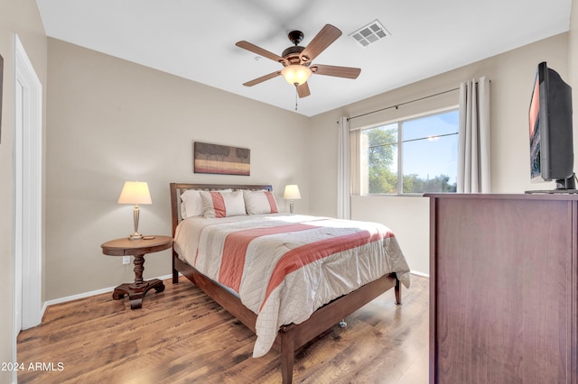 bedroom with hardwood / wood-style floors and ceiling fan