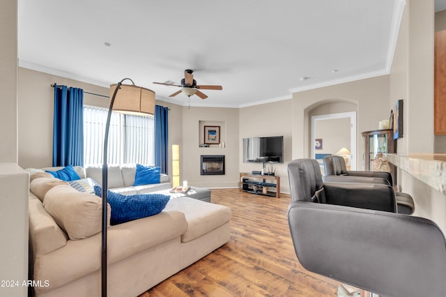 living room featuring ceiling fan, hardwood / wood-style floors, and ornamental molding