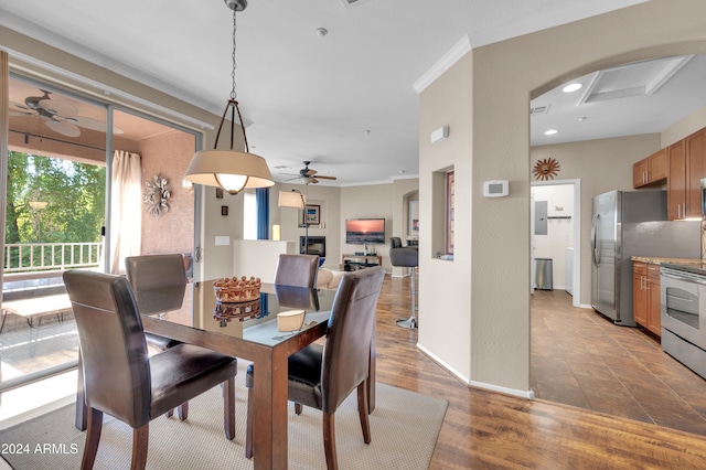 dining area with hardwood / wood-style flooring, ceiling fan, and ornamental molding