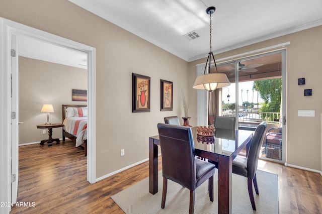 dining room featuring dark hardwood / wood-style flooring, ceiling fan, and ornamental molding